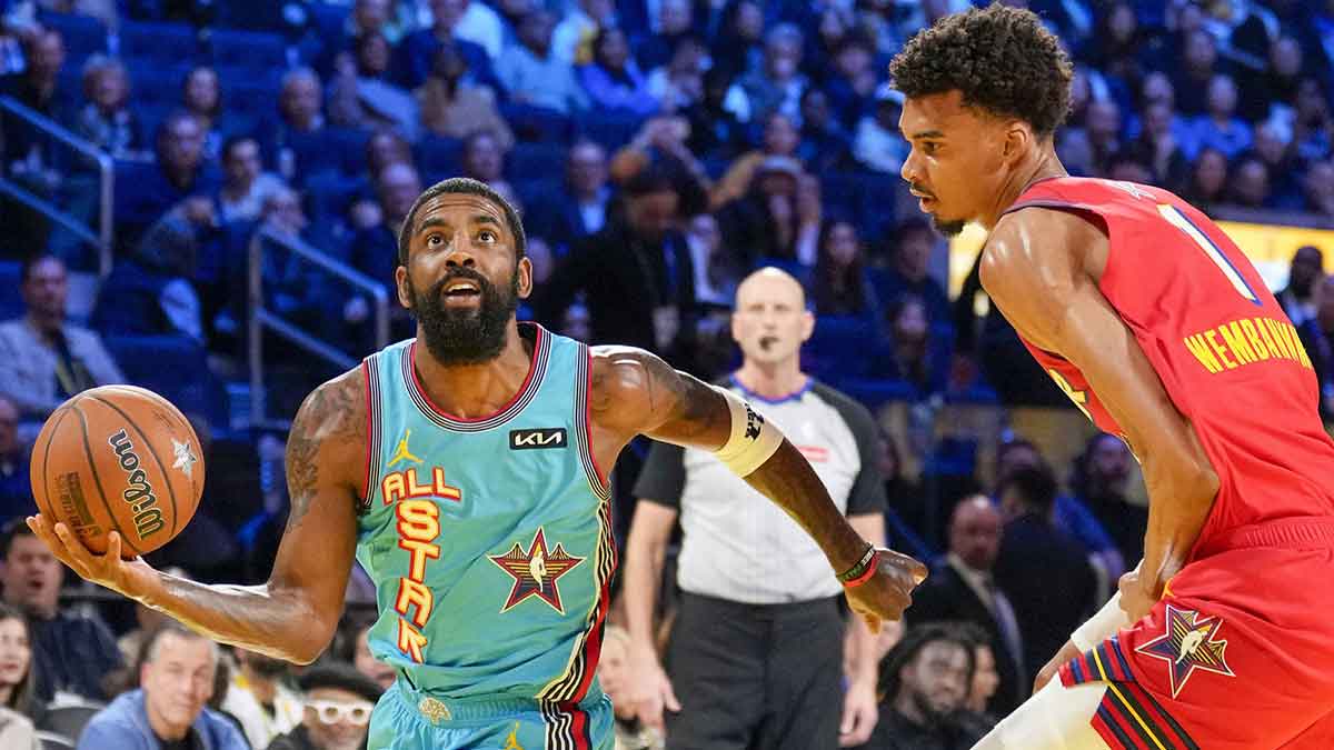 Shaq’s OGs guard Kyrie Irving (11) of the Dallas Mavericks controls the ball against Chuck’s Global Stars forward Victor Wembanyama (1) of the San Antonio Spurs during the 2025 NBA All Star Game at Chase Center.