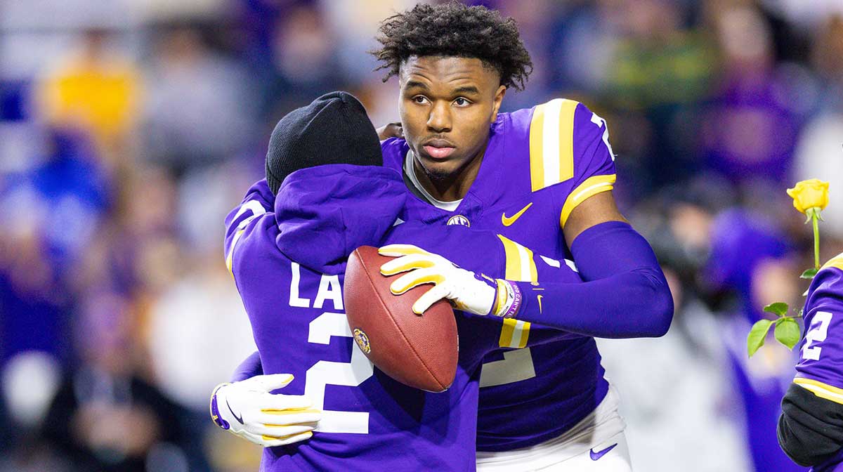 LSU Tigers wide receiver Kyren Lacy (2) hugs his family as seniors are being honored during the beginning of the first quarter at Tiger Stadium