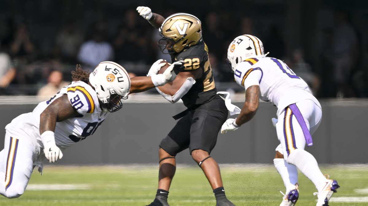 Vanderbilt Commodores running back Makhilyn Young (22) avoids the tackle of Louisiana State Tigers defensive tackle Jacobian Guillory (90) during the second half at FirstBank Stadium. Mandatory Credit: Steve Roberts-Imagn Images