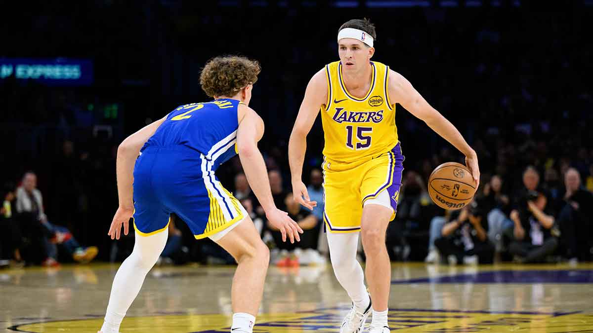 Los Angeles Lakers guard Austin Reaves (15) dribbles against Golden State Warriors guard Brandin Podziemski (2) during the first half at Crypto.com Arena.