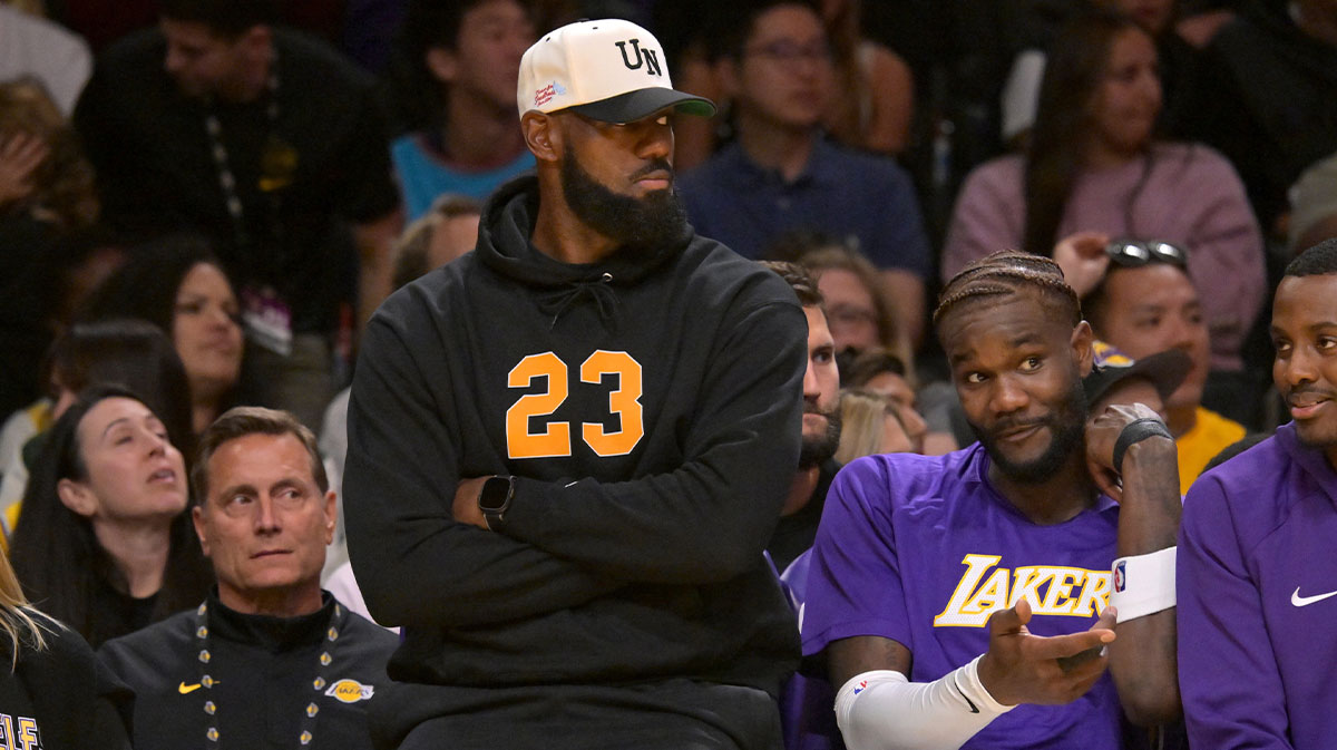 Lakers forward Lebron James (23) looks on from the bench during the first half against the Golden State Warriors at Crypto.com Arena with Lou Williams in the background