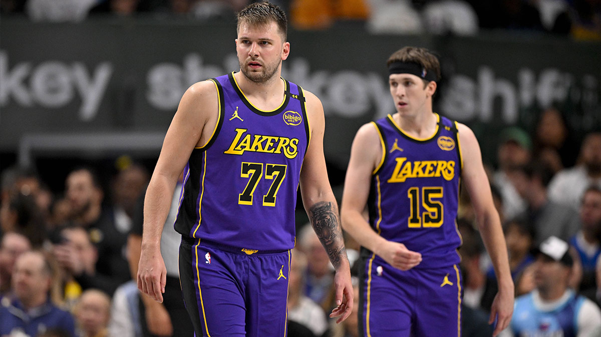 Lakers guard Luka Doncic (77) and guard Austin Reaves (15) during the game between the Dallas Mavericks and the Los Angeles Lakers at American Airlines Center with Mavericks GM Nico Harrison in the background