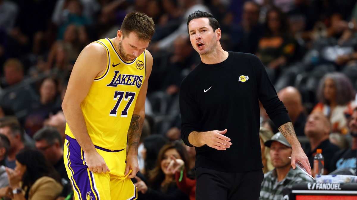 Lakers guard Luka Doncic (77) with head coach JJ Redick against the Phoenix Suns during an NBA preseason game at Mortgage Matchup Center