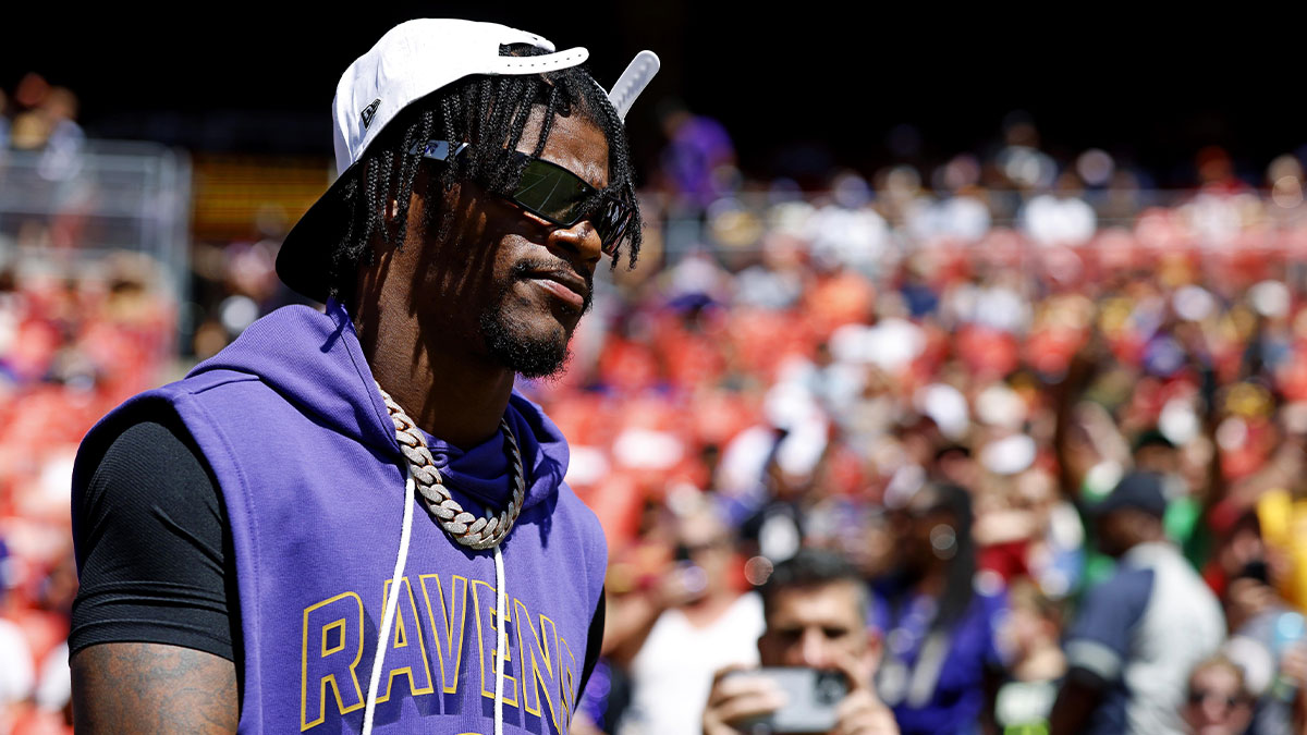 Baltimore Ravens quarterback Lamar Jackson (8) walks on the field before the game against the Washington Commanders at Northwest Stadium.