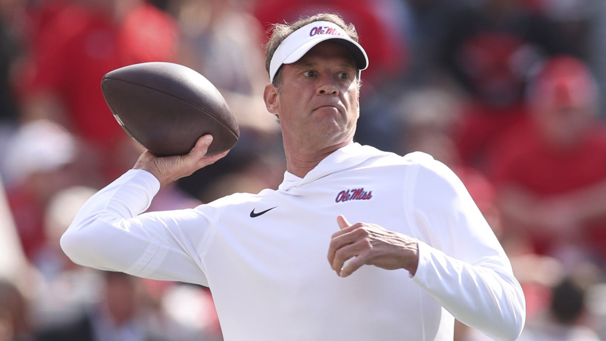 Mississippi Rebels head coach Lane Kiffin throws the ball prior to the game against the Georgia Bulldogs at Sanford Stadium.
