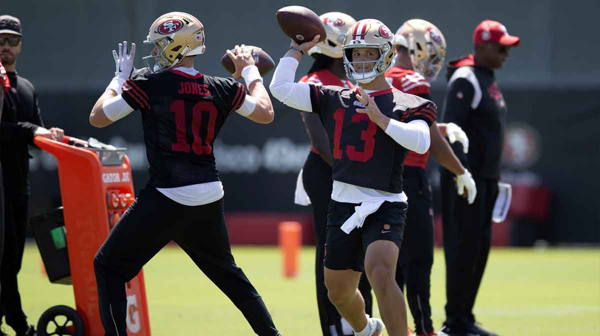 San Francisco 49ers quarterbacks Mac Jones (10) and Brock Purdy (13) work on passing drills during a team OTA at Levi's Stadium.