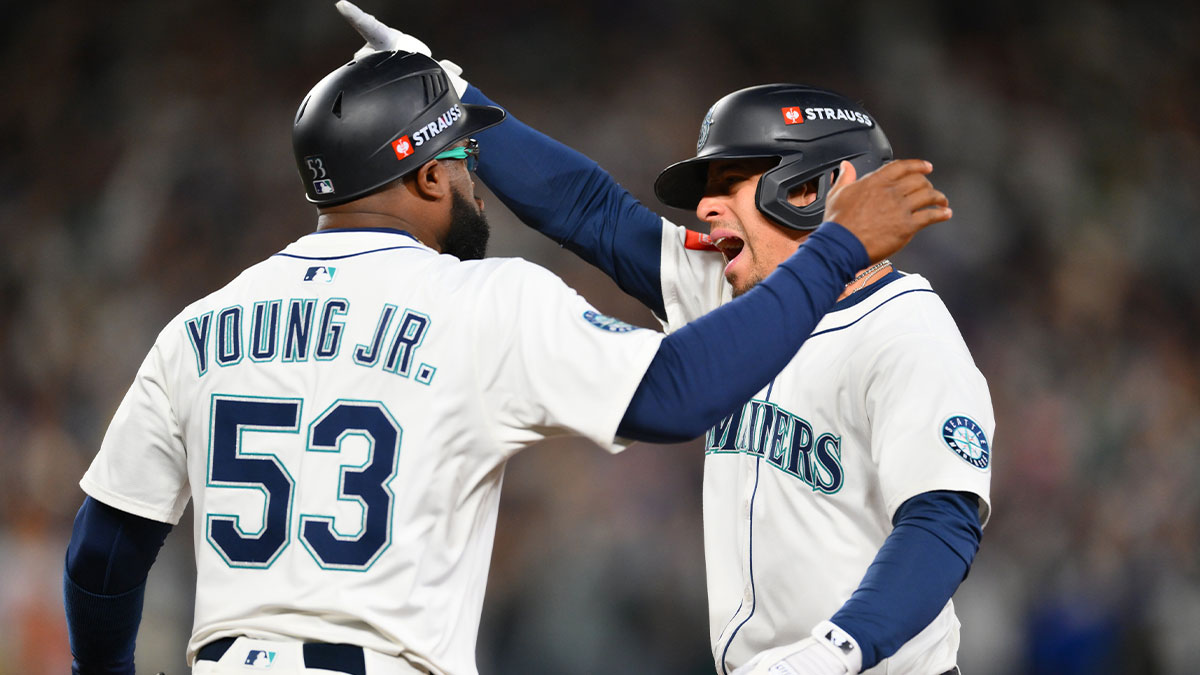 Seattle Mariners second baseman Leo Rivas (76) celebrates an RBI single with first base coach Eric Young Jr. (53) against the Detroit Tigers during the seventh inning during game five of the ALDS round for the 2025 MLB playoffs at T-Mobile Park.
