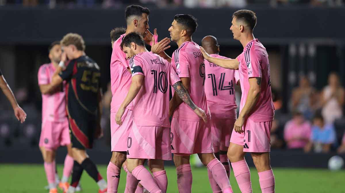 Inter Miami CF forward Luis Suarez (9) celebrates with midfielder Sergio Busquets (5) and forward Lionel Messi (10) after scoring against Atlanta United during the second half at Chase Stadium.