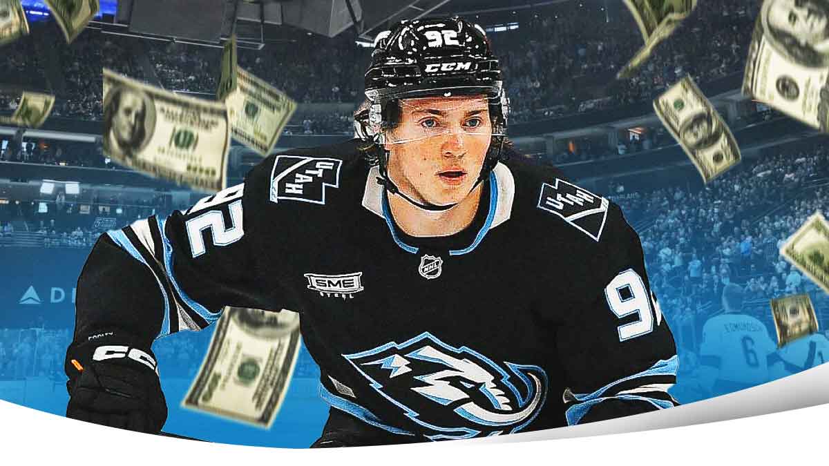 Utah Mammoth star Logan Cooley with money raining around him.