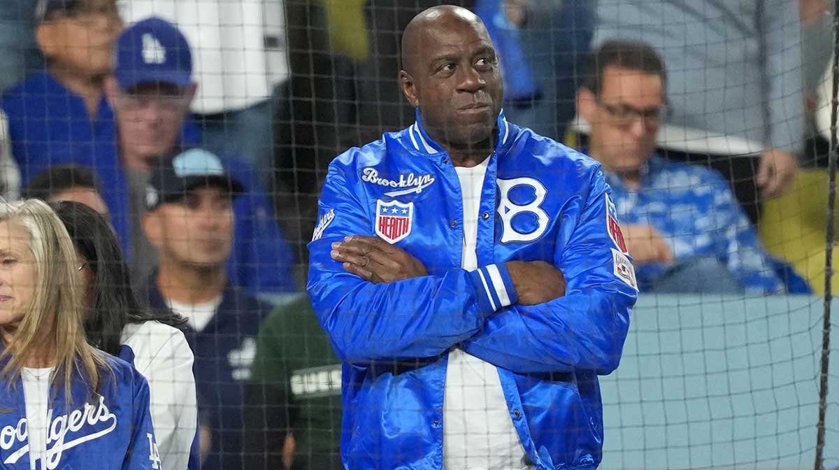 Oct 17, 2025; Los Angeles, California, USA; Los Angeles Dodgers co-owner Magic Johnson looks on in the sixth inning between the Los Angeles Dodgers and the Milwaukee Brewers during game four of the NLCS round for the 2025 MLB playoffs at Dodger Stadium. Mandatory Credit: Kirby Lee-Imagn Images
