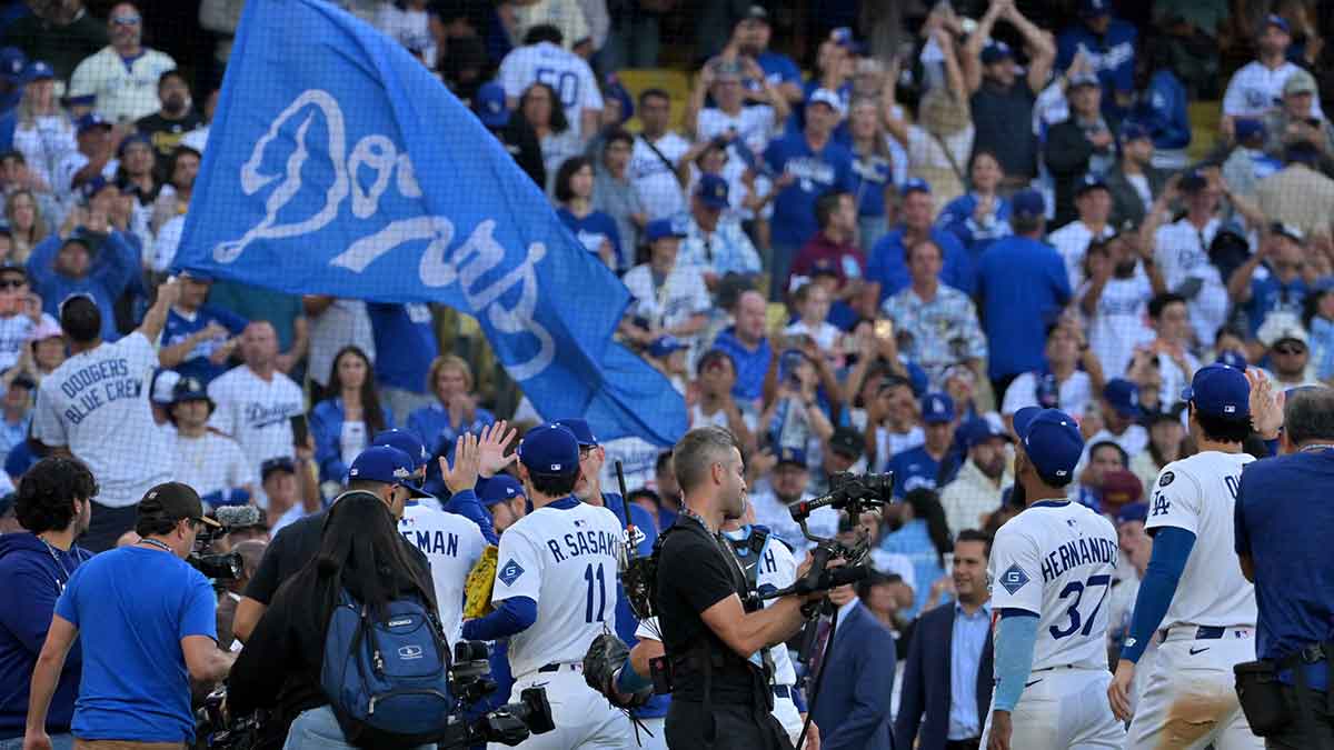 Los Angeles Dodgers leave the field after the final out of the ninth inning of game three of the NLCS during the 2025 MLB playoffs against the Milwaukee Brewers at Dodger Stadium. Mandatory Credit: Jayne Kamin-Oncea-Imagn Images