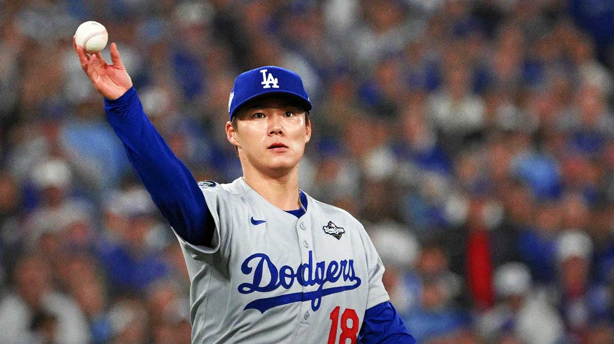 Los Angeles Dodgers pitcher Yoshinobu Yamamoto (18) throws to first base to get out Toronto Blue Jays left fielder Nathan Lukes (not pictured) in the fifth inning during game two of the 2025 MLB World Series at Rogers Centre. Mandatory Credit: Dan Hamilton-Imagn Images