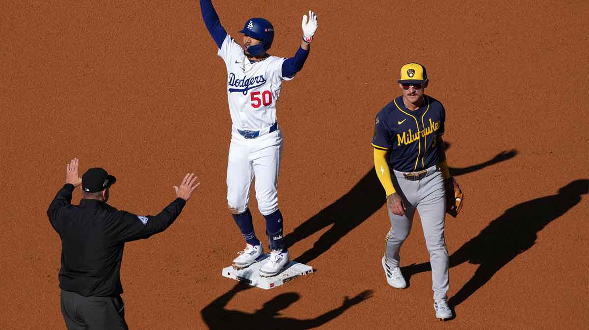 Los Angeles Dodgers shortstop Mookie Betts (50) reacts after hitting a RBI double against the Milwaukee Brewers in the first inning during game three of the NLCS round for the 2025 MLB playoffs at Dodger Stadium.