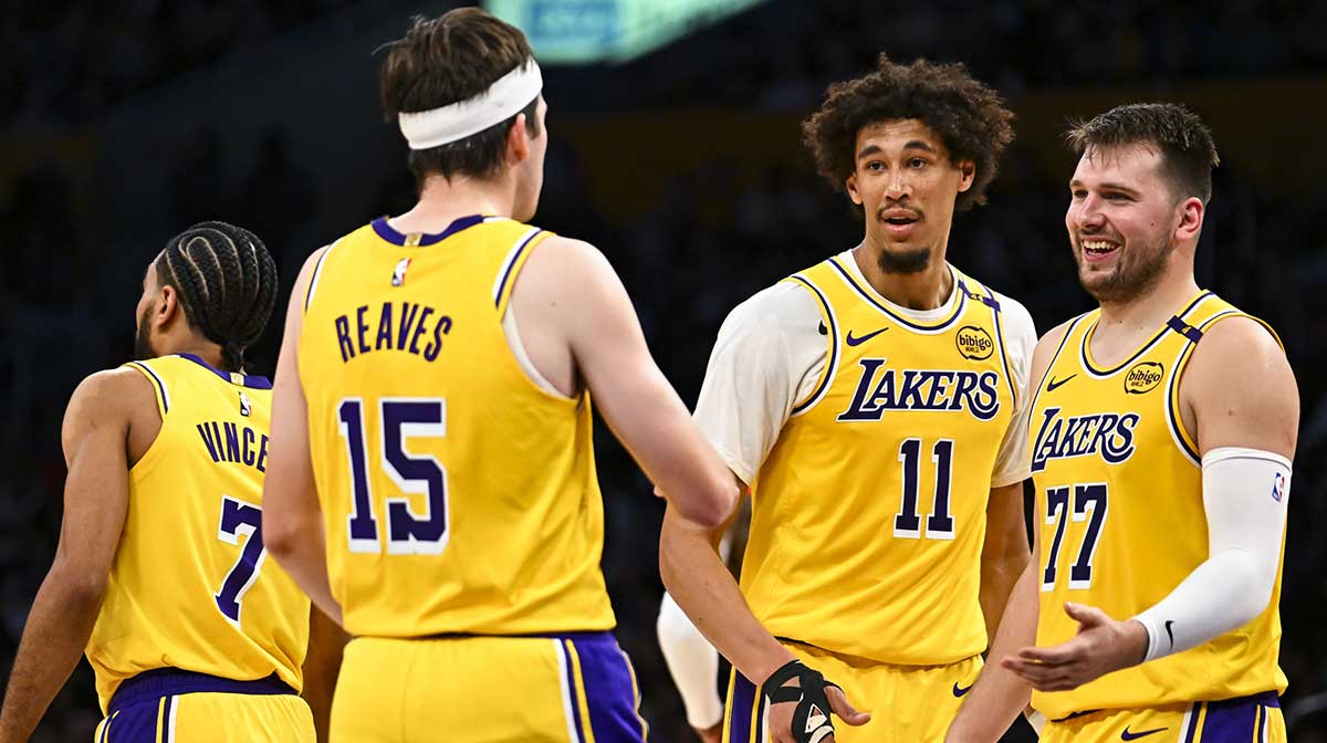 Los Angeles Lakers guard Luka Doncic (77) celebrates with center Jaxson Hayes (11), and guard Austin Reaves (15) after scoring against the Houston Rockets during the first half at Crypto.com Arena.