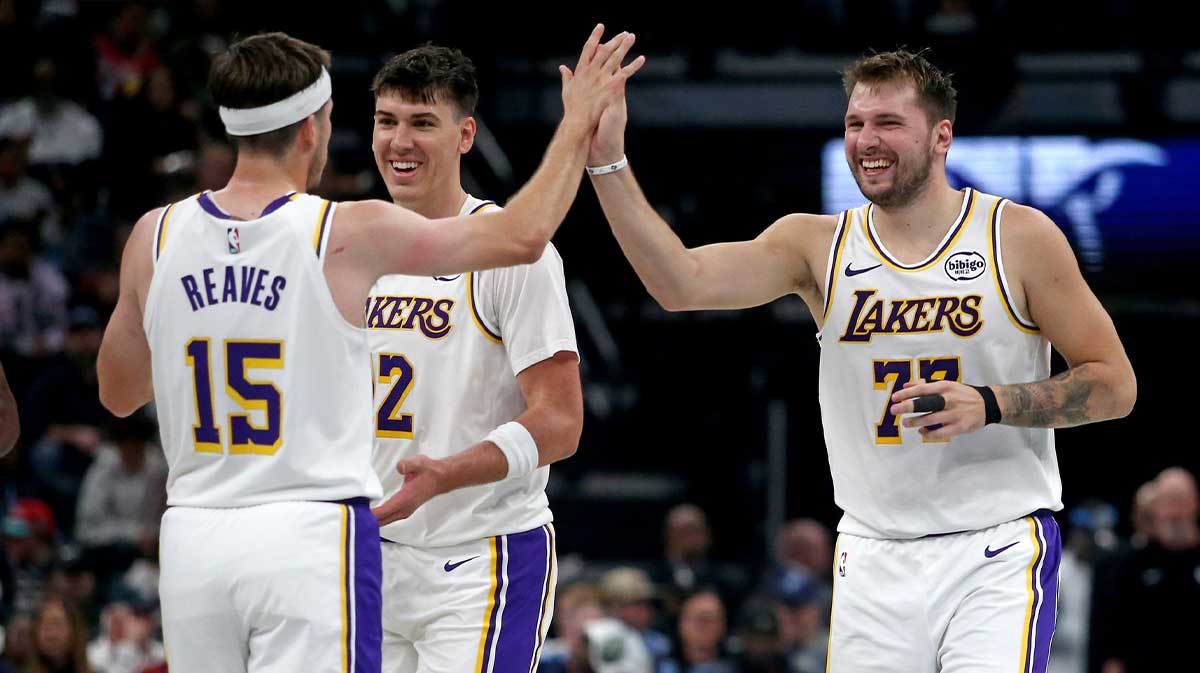 Los Angeles Lakers guard Luka Doncic (77) reacts with guard Austin Reaves (15) during a timeout during the second quarter against the Memphis Grizzlies at FedExForum.