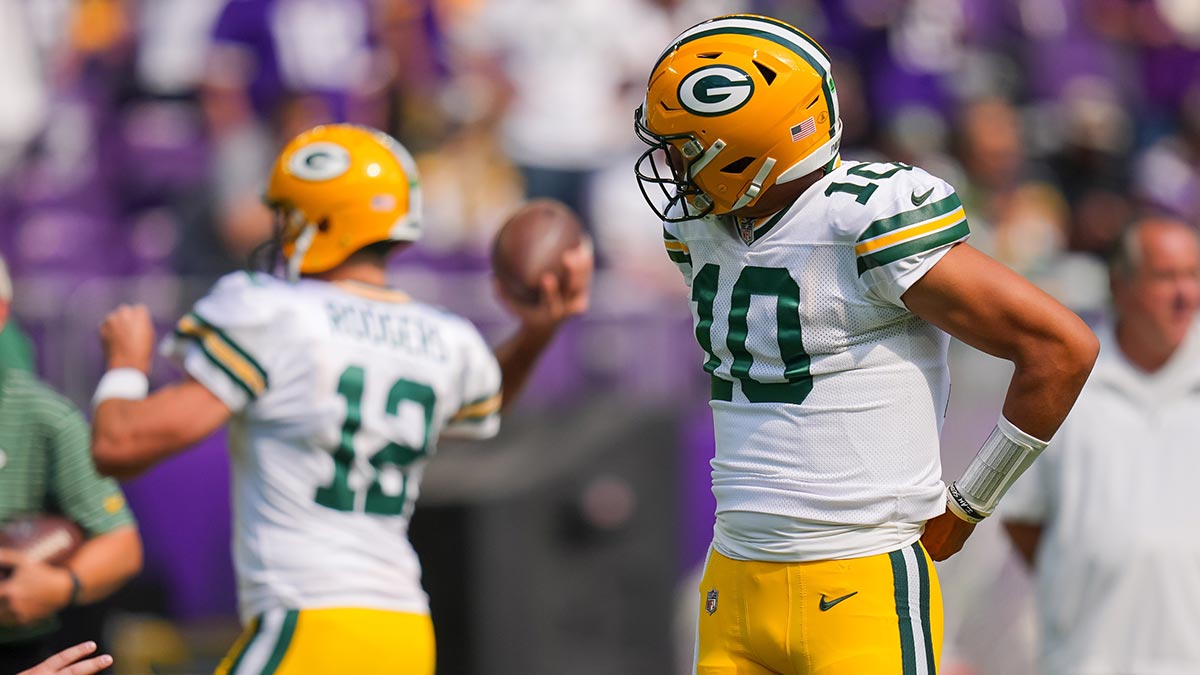 Green Bay Packers quarterback Jordan Love (10) watches quarterback Aaron Rodgers (12) warm up before the game against the Minnesota Vikings at U.S. Bank Stadium.