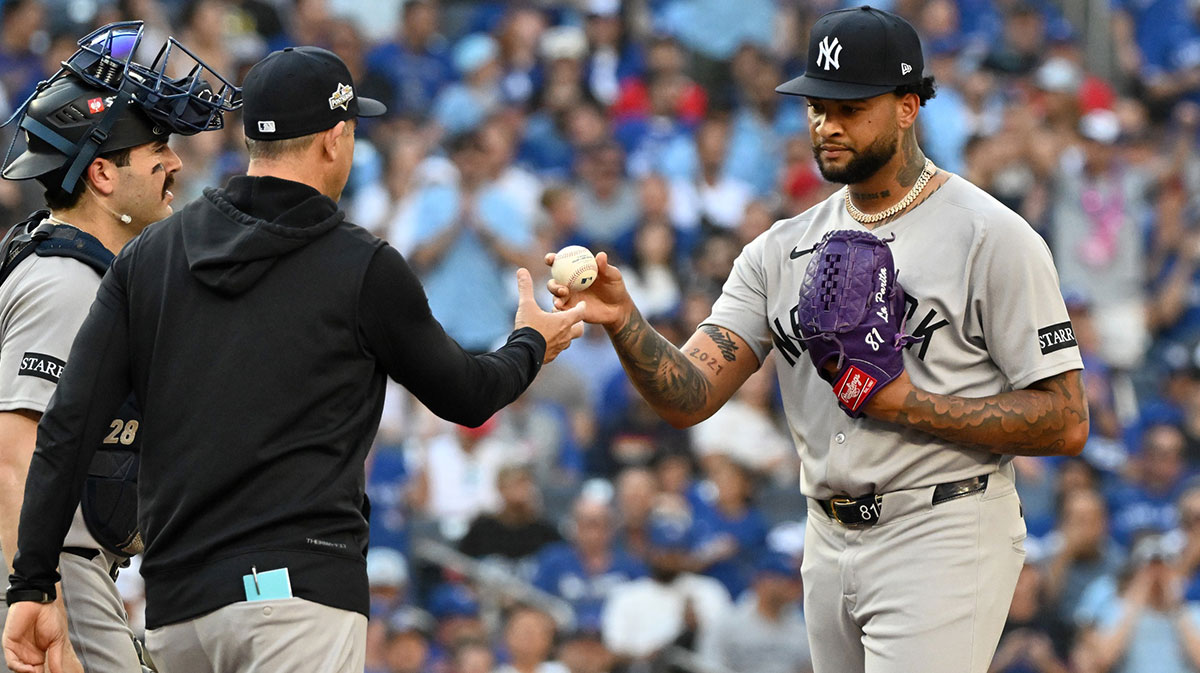 New York Yankees pitcher Luis Gil (81) is relieved by manager Aaron Boone (17) in the third inning against the Toronto Blue Jays during game one of the ALDS round for the 2025 MLB playoffs at Rogers Centre.