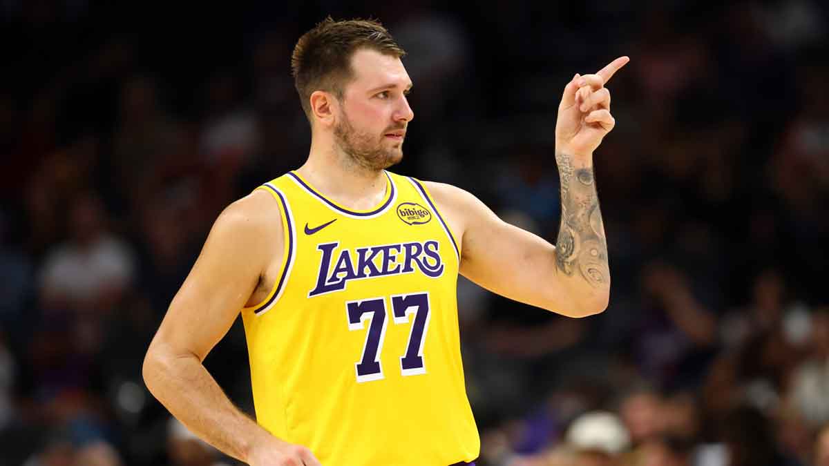 Los Angeles Lakers guard Luka Doncic (77) reacts against the Phoenix Suns during an NBA preseason game at Mortgage Matchup Center.