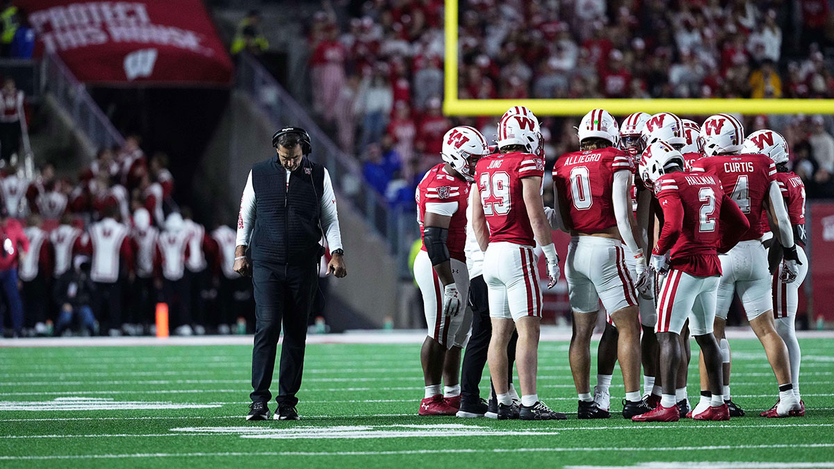 Wisconsin Badgers head coach Luke Fickell and his team take a timeout in the second half against the Iowa Hawkeyes at Camp Randall Stadium.