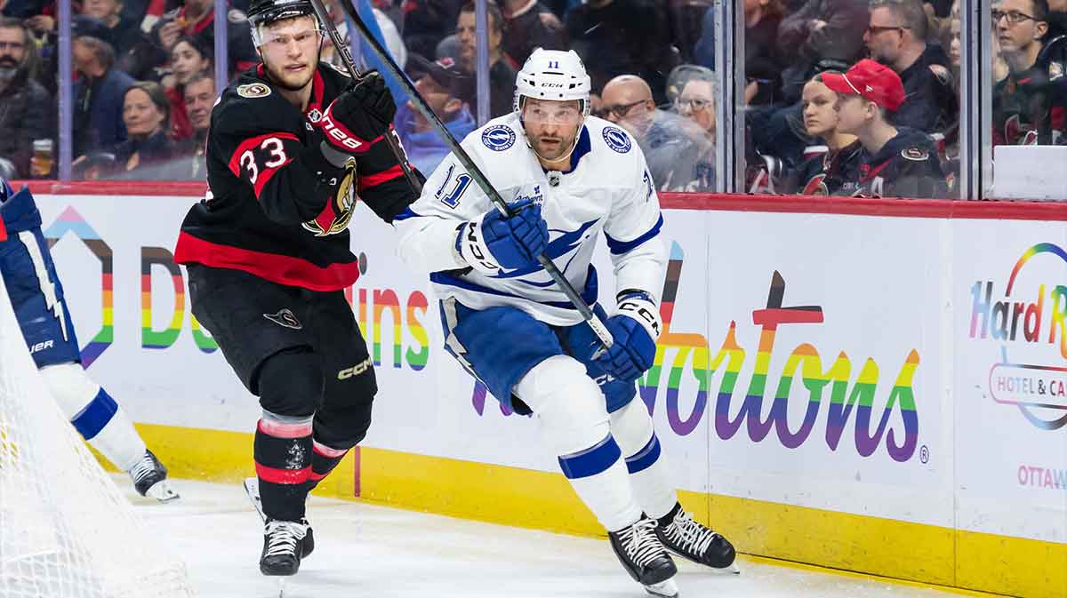 Ottawa Senators defenseman Nikolas Matinpalo (3) and Tampa Bay Lightning center Luke Glendening (11) chase the puck in the second period at the Canadian Tire Centre.
