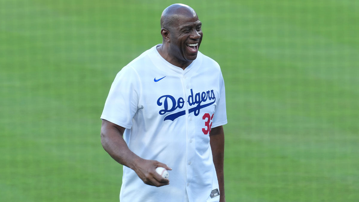 Los Angeles Dodgers co owner Magic Johnson reacts before throwing the ceremonial first pitch before game five of the 2025 MLB World Series between the Toronto Blue Jays and the Los Angeles Dodgers at Dodger Stadium.