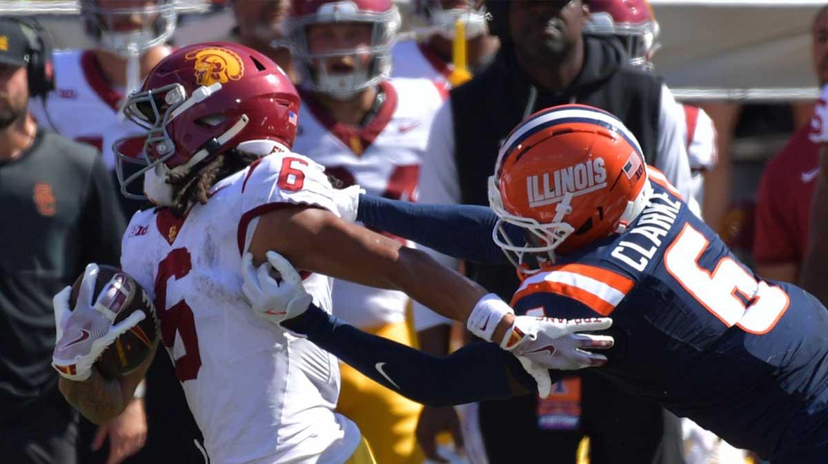 Illinois Fighting Illini defensive back Jaheim Clarke (6) pursues Southern California Trojans wide receiver Makai Lemon (6) during the second half at Memorial Stadium.