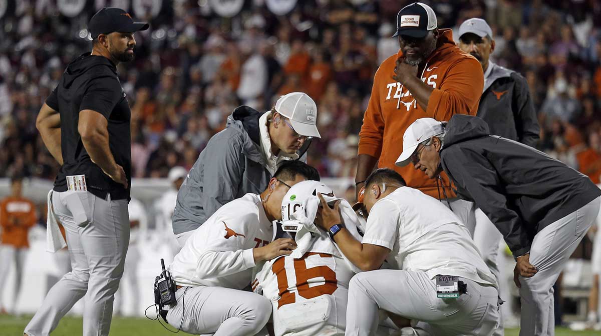 Medical staff check on Texas Longhorns quarterback Arch Manning (16) during overtime against the Mississippi State Bulldogs at Davis Wade Stadium at Scott Field