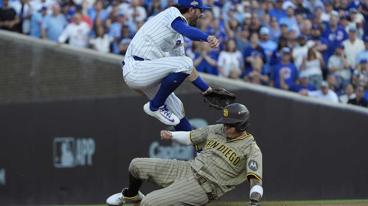 Chicago Cubs shortstop Dansby Swanson (7) tags out San Diego Padres third baseman Manny Machado (13) during the sixth inning during game three of the Wildcard round for the 2025 MLB playoffs at Wrigley Field.