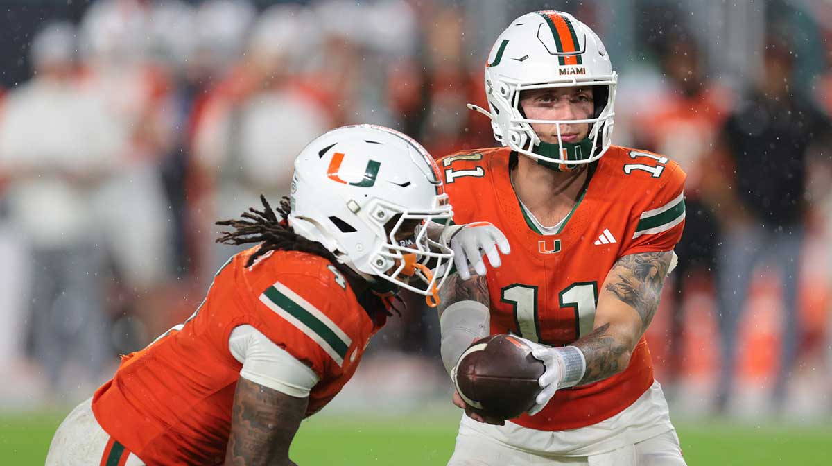 Florida Gators wide receiver Aidan Mizell (11) handoffs the football to running back Mark Fletcher Jr. (4) against the Florida Gators during the fourth quarter at Hard Rock Stadium.