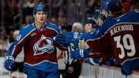Colorado Avalanche center Martin Necas (88) celebrates with the bench after his goal in the first period against the New Jersey Devils at Ball Arena.