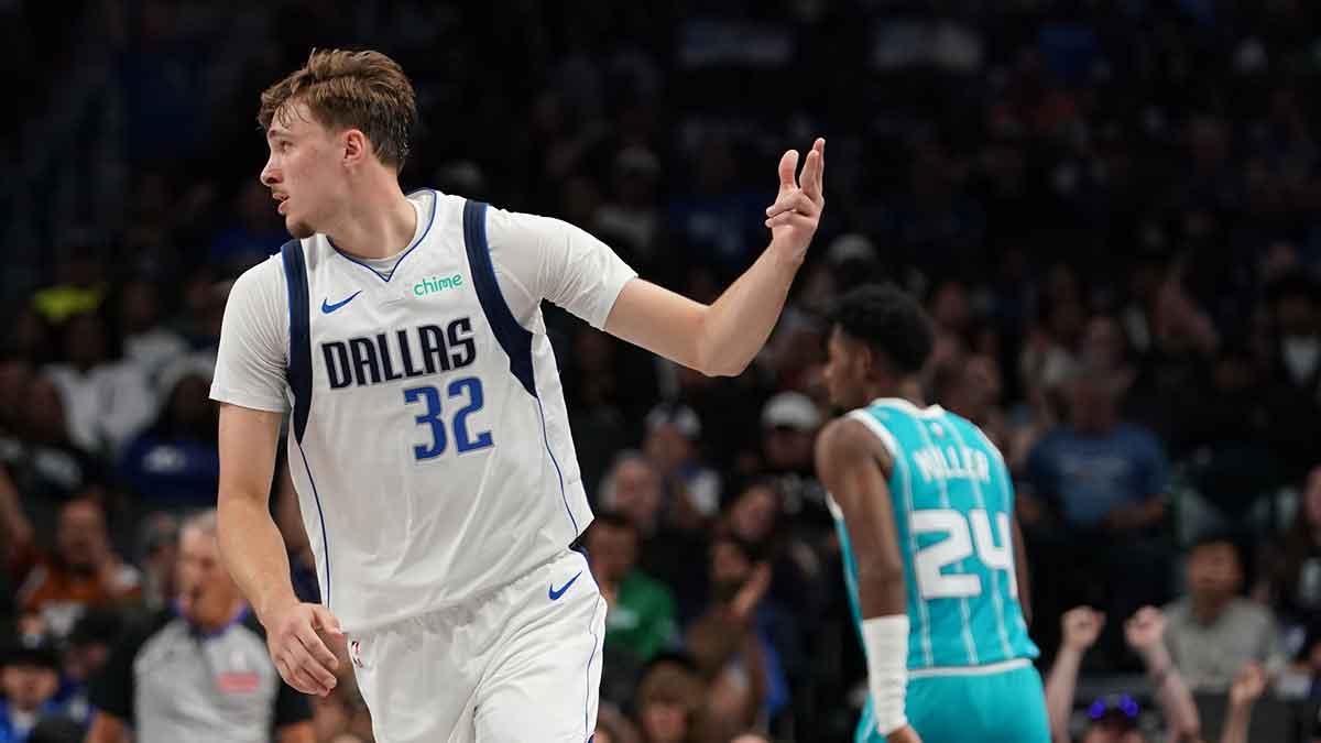 Dallas Mavericks forward Cooper Flagg (32) reacts after making a basket against the Charlotte Hornets in the first half of a game at American Airlines Center.