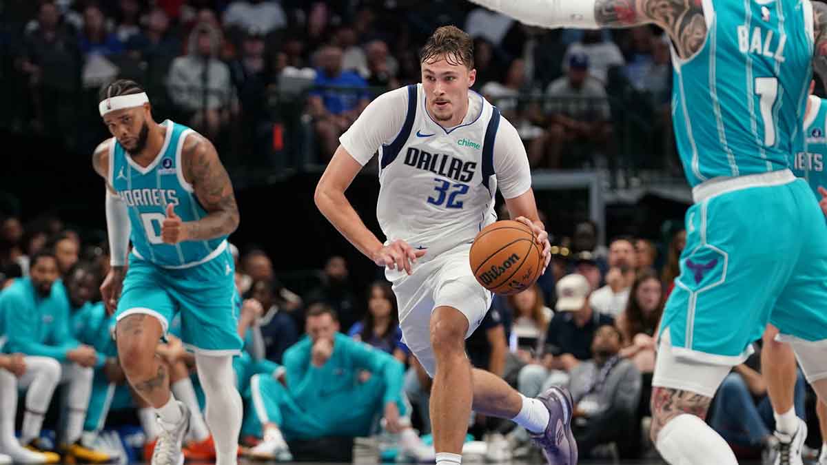 Dallas Mavericks forward Cooper Flagg (32) dribbles up court against the Charlotte Hornets in the second half of a game at American Airlines Center.