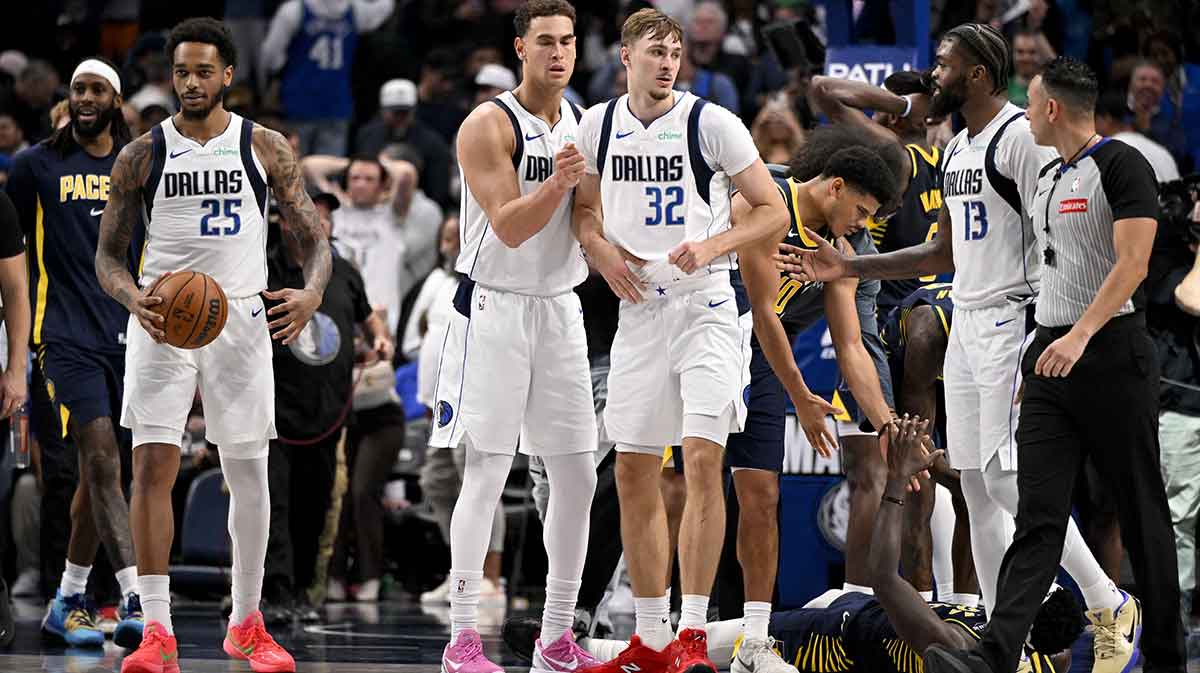 Dallas Mavericks forward P.J. Washington (25) and forward Dwight Powell (7) and forward Cooper Flagg (32) and forward Naji Marshall (13) react to the win over the Indiana Pacers at the American Airlines Center.