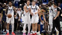 Dallas Mavericks forward P.J. Washington (25) and forward Dwight Powell (7) and forward Cooper Flagg (32) and forward Naji Marshall (13) react to the win over the Indiana Pacers at the American Airlines Center.