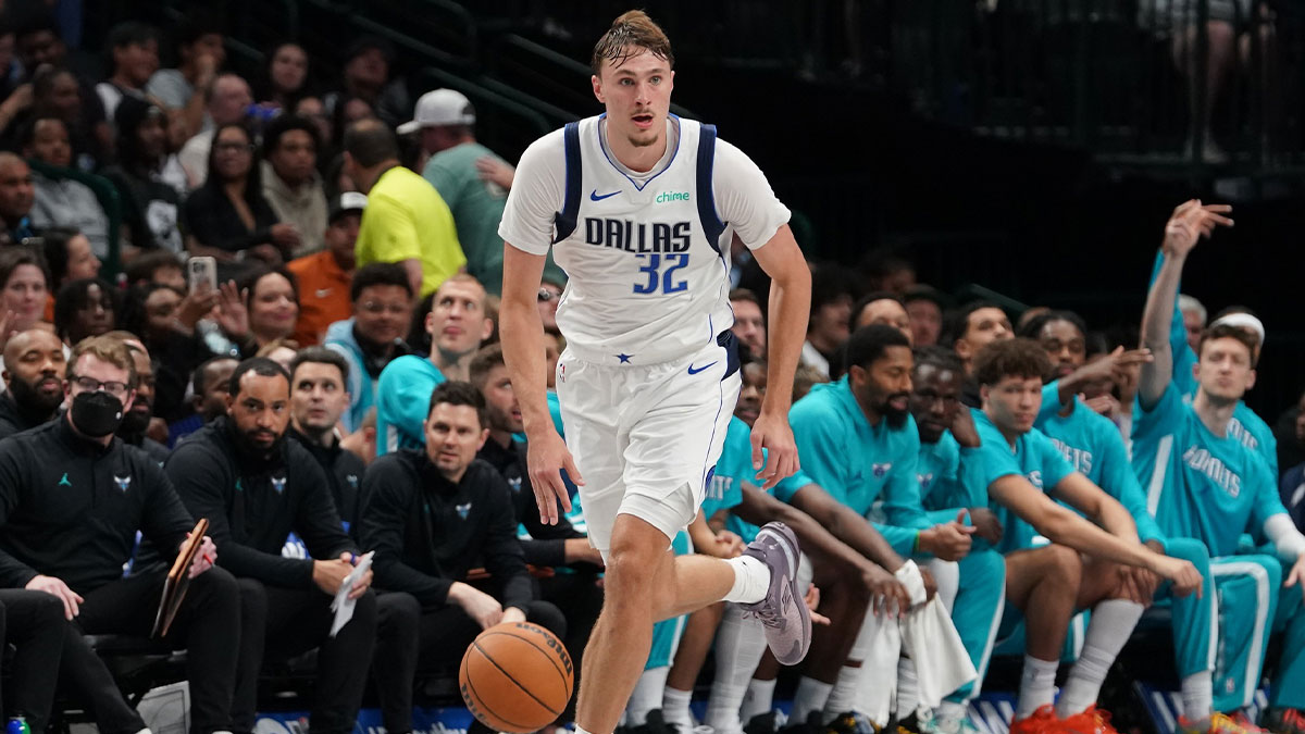 ; Dallas Mavericks forward Cooper Flagg (32) brings the ball up court against the Charlotte Hornets in the second half of a game at American Airlines Center.