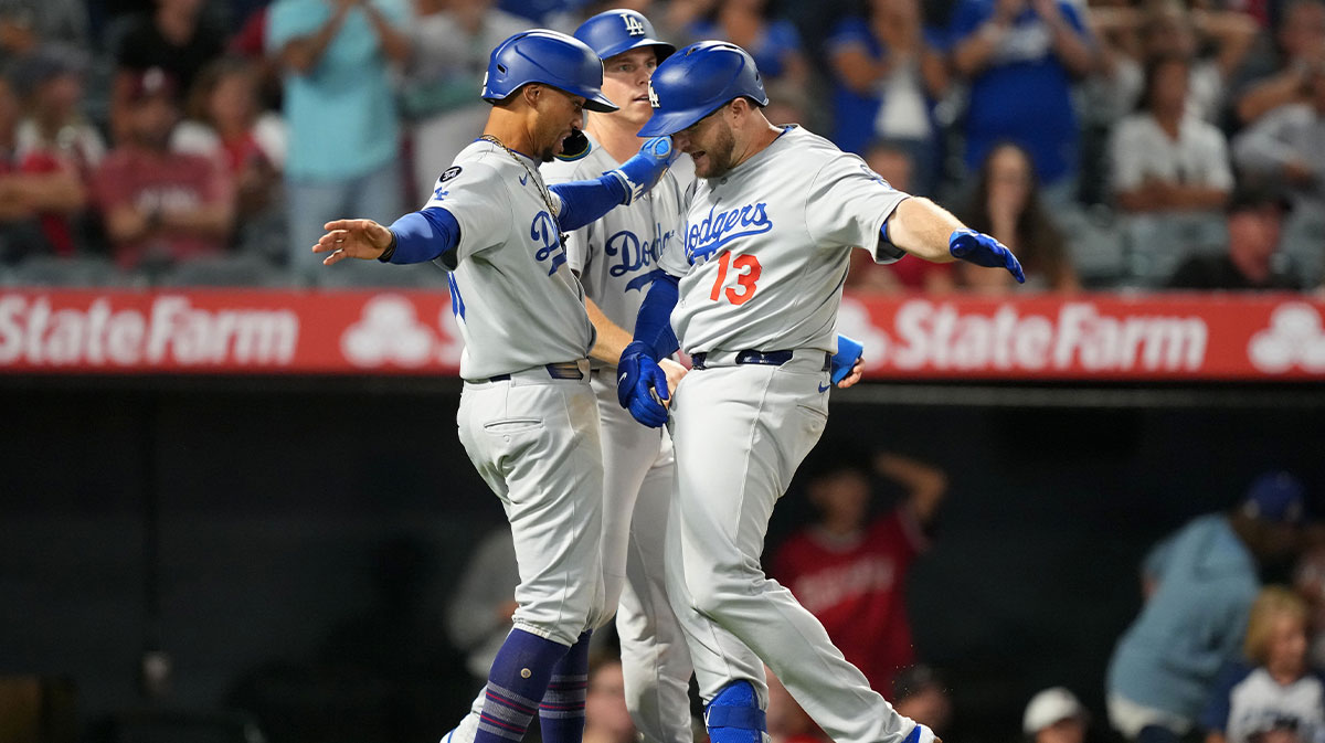 Los Angeles Dodgers third baseman Max Muncy (13) celebrates with shortstop Mookie Betts (50) after hitting a three-run home run in the eighth inning against the Los Angeles Angels at Angel Stadium.