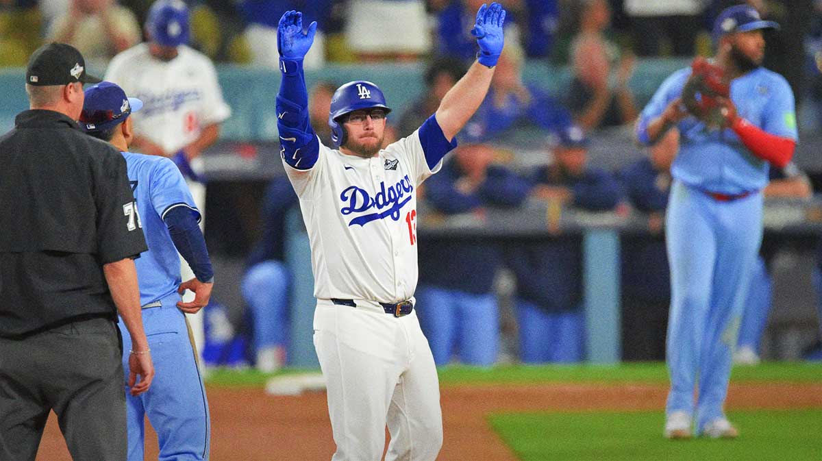 Los Angeles Dodgers third baseman Max Muncy (13) celebrates after hitting a double during the ninth inning against the Toronto Blue Jays during game four of the 2025 MLB World Series at Dodger Stadium.