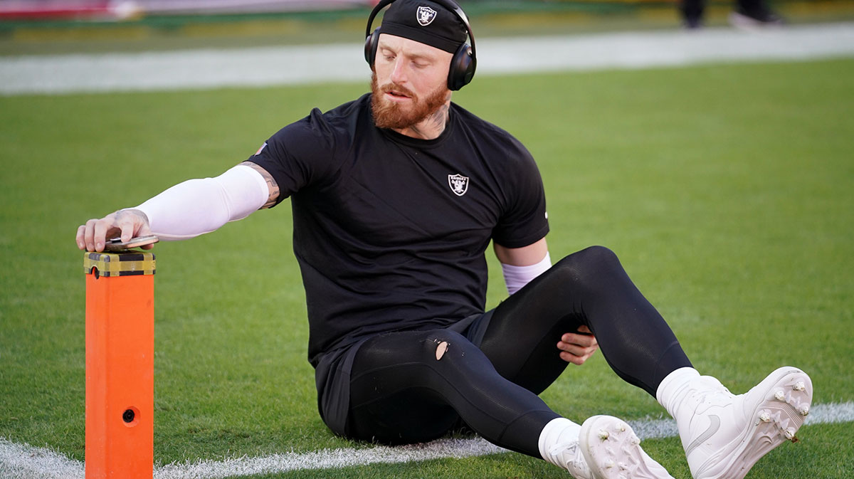 Las Vegas Raiders defensive end Maxx Crosby (98) stretches during warmups prior to the game against the Kansas City Chiefs at GEHA Field at Arrowhead Stadium.