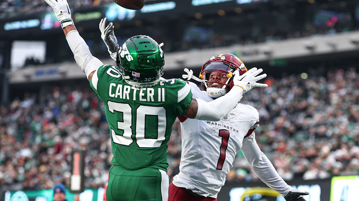 New York Jets cornerback Michael Carter II (30) breaks up a pass intended for Washington Commanders wide receiver Jahan Dotson (1) during the second half at MetLife Stadium.