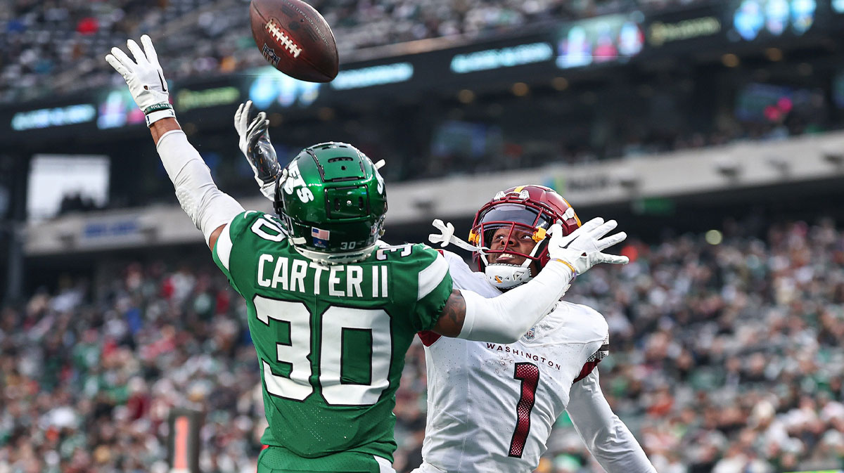 New York Jets cornerback Michael Carter II (30) breaks up a pass intended for Washington Commanders wide receiver Jahan Dotson (1) during the second half at MetLife Stadium.