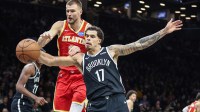 Atlanta Hawks center Kristaps Porzingis (8) and Brooklyn Nets forward Michael Porter Jr. (17) fight for a loose ball in the fourth quarter at Barclays Center.
