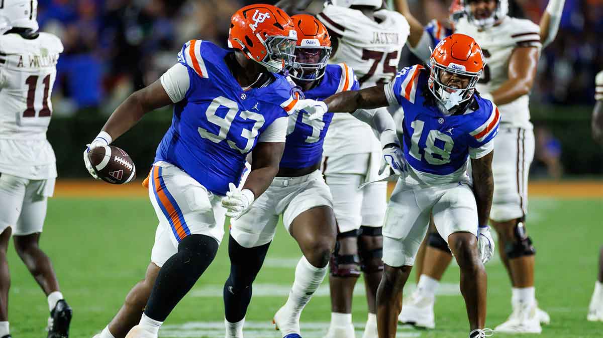 Florida Gators defensive tackle Michai Boireau (93) celebrates with safety Bryce Thornton (18) after an interception during the second half at Ben Hill Griffin Stadium.