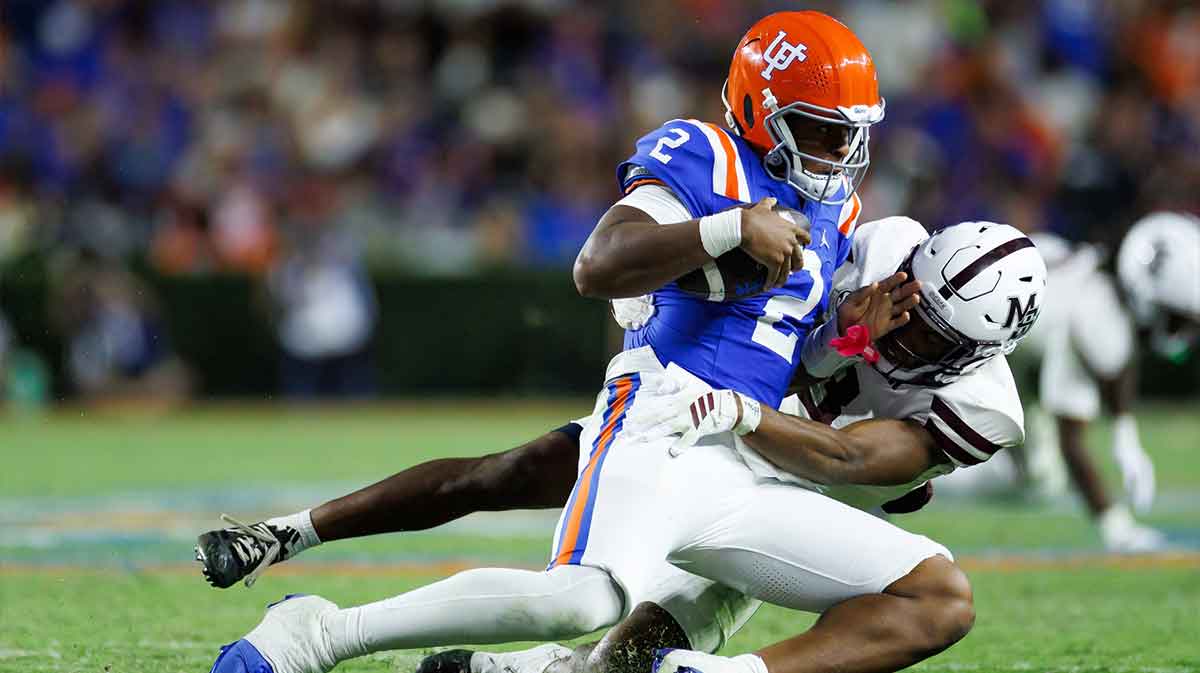 Mississippi State Bulldogs safety Brylan Lanier (3) tackles Florida Gators quarterback DJ Lagway (2) during the second half at Ben Hill Griffin Stadium.