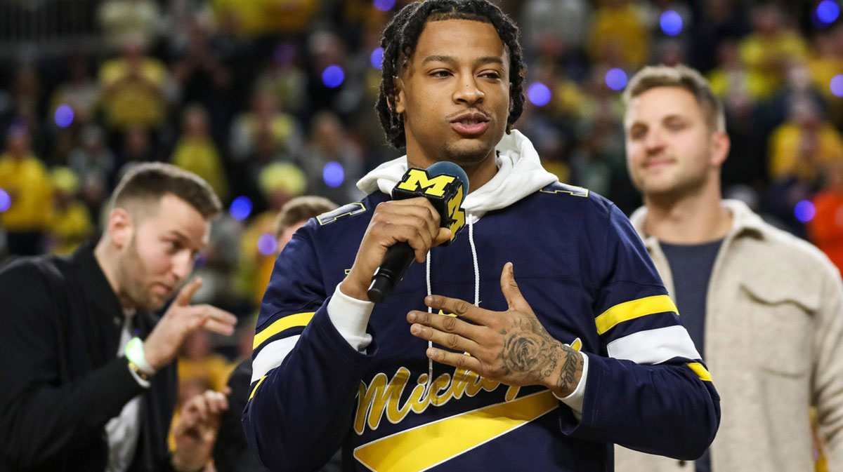 Trey Burke speaks during halftime as Michigan honors the 10-year anniversary of the 2013 run to the Final Four and national title game at Crisler Center in Ann Arbor on Saturday, Feb. 18, 2023.
