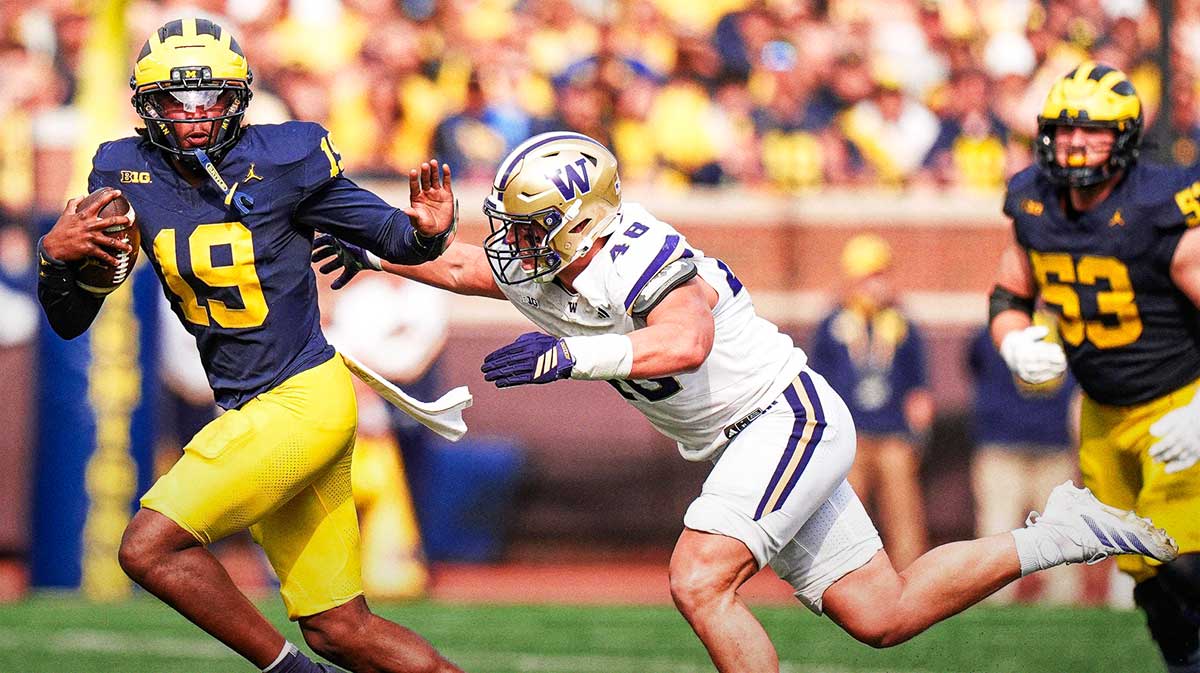 Michigan quarterback Bryce Underwood (19) keeps the ball and runs against Washington safety Rylon Dillard-Allen (18) during the second half at Michigan Stadium in Ann Arbor on Saturday, Oct. 18, 2025.