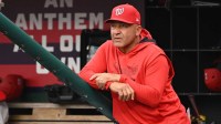 Washington Nationals interim manager Miguel Cairo (22) looks out from the dugout against the Athletics during the first inning at Nationals Park.