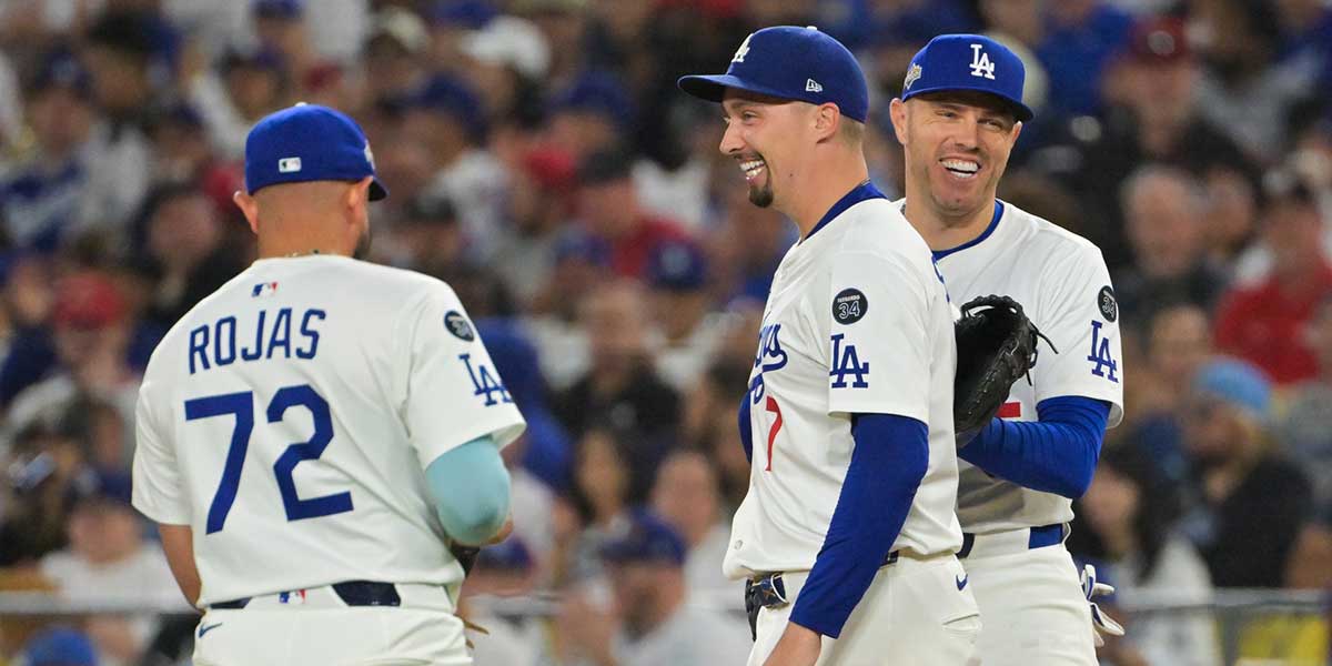 Los Angeles Dodgers starting pitcher Blake Snell (7) celebrates with Los Angeles Dodgers second baseman Miguel Rojas (72) after a strikeout during the sixth inning against the Cincinnati Reds during game one of the Wildcard round for the 2025 MLB playoffs at Dodger Stadium. 