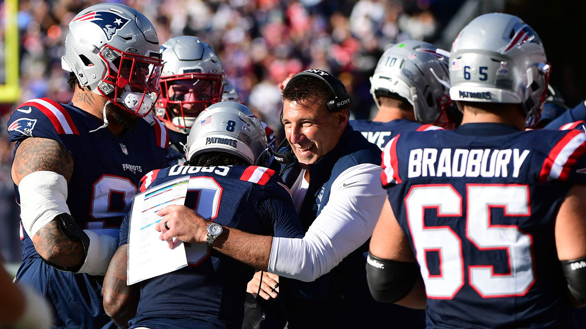 New England Patriots wide receiver Stefon Diggs (8) celebrates scoring a touchdown with head coach Mike Vrabel during the third quarter against the Cleveland Browns at Gillette Stadium.