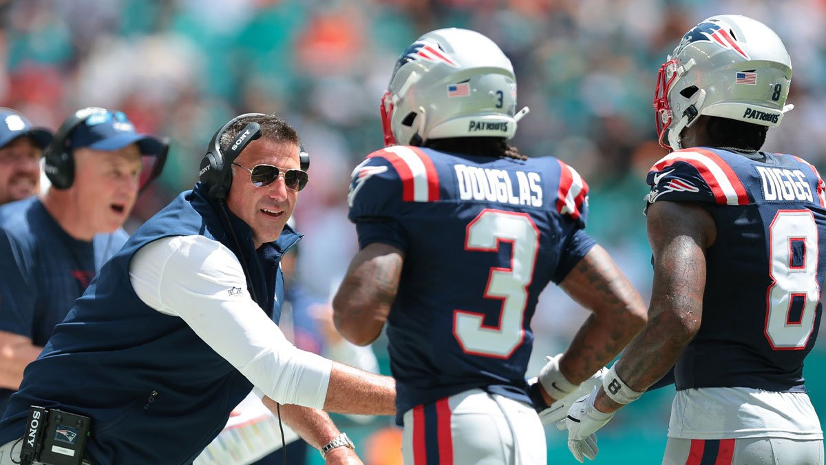 New England Patriots head coach Mike Vrabel celebrates with wide receiver DeMario Douglas (3) and wide receiver Stefon Diggs (8) against the Miami Dolphins during the first quarter at Hard Rock Stadium.