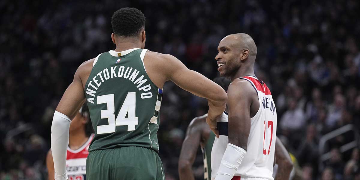 Milwaukee Bucks forward Giannis Antetokounmpo (34) and Washington Wizards forward Khris Middleton (22) joke around during their game at Fiserv Forum.